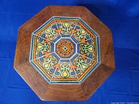 Top view showing octagonal wood frame and colourful ceramic tile mosaic inset