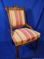 Full front view of chair showing upholstery, frame and casters