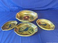 All four nesting Mexican ceramic bowls laid out to show sizes and painted motifs