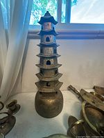 Brass multi-tier pagoda tower on table