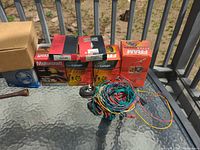 Row of oil filter boxes, spark plug pack, wiring bundle, loose bulb