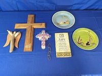 Group shot of all eight wall-hanging items on blue background
