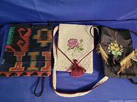 Three embroidered fabric shoulder bags front view