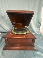 Full view of Columbia Grafonola tabletop phonograph with lid open showing green felt turntable and tonearm