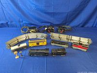 Entire lot showing locomotive, six cars, track stacks and transformers