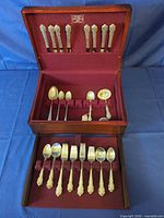 Open chest showing knives in lid, spoons and forks in trays