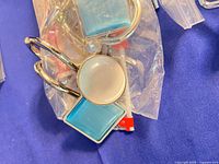 Bagged decorative shower curtain hooks with blue and white resin accents
