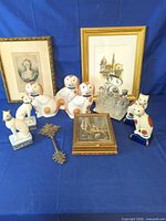 Group shot of all figurines, cruet set, framed prints and metal cross key