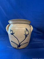 Front view of stoneware crock with cobalt floral motif and handles