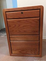 Front view of oak two-drawer filing cabinet showing lock on top drawer