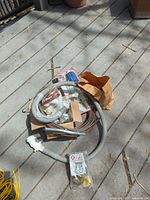 Assortment of hoses, fittings and packaged parts on deck