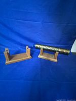 Kaleidoscope and two wooden stands on blue backdrop