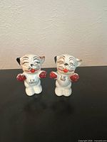 Pair of white animal shakers labeled I'M SALT and I'M PEPPER