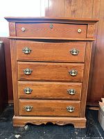 front view of dresser showing five drawers and hardware