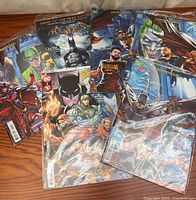 Group of six bagged Batman⁄FaZe Clan comics spread on table