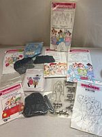 Group shot of all eight Art Impressions stamp sets with packaging, index cards and grey foam stamps visible