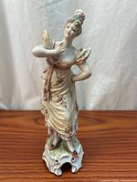 Full view of porcelain lady figurine on scroll base