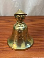 Front view of brass figural emperor bell
