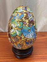 Front view cloisonné egg on stand showing butterfly motifs