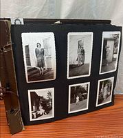 Album exterior showing brown cover, corded binding and page with six bordered photographs of woman outside house