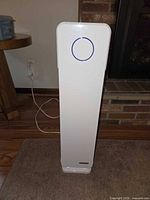 Front view of white tower air purifier showing circular LED ring