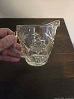 Front view of clear pressed-glass creamer showing Star of David motif