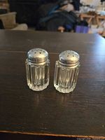 Front view of both glass shakers with metal lids