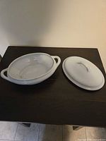 Covered serving bowl with lid separated showing interior glaze and handles