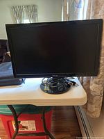 Front view of Asus monitor on stand with cables