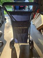 Front view showing Nantucket Beach Buggy logo, mesh storage, handle and wheels