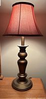 Full view of one lamp showing base and shade