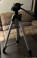 Tripod fully extended showing legs, pan head, handle