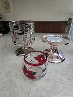 Three different holders: mosaic pedestal, metal pedestal, poinsettia votive