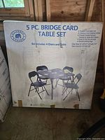 Front of sealed box showing image of table and chairs