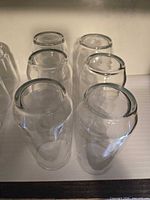Six clear double-wall tumblers upright