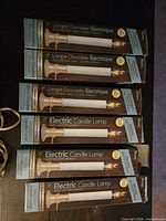 Six boxed electric candles showing packaging details