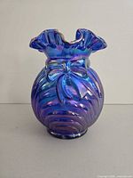 Front view showing bow detail, iridescent finish, ruffled rim