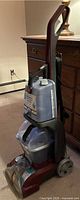 Left side view of full carpet cleaner showing tanks and handle