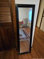 Front view of rectangular mirror with black frame