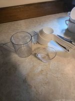 White plastic nesting dry measuring cups, clear plastic liquid measuring cup, small clear liquid cup