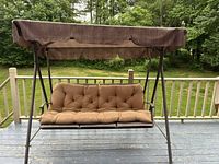 Full front view of swing showing cushion and canopy