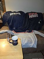 Three hoodies displayed on sofa