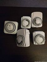 Front view of all five timers showing rotary dials