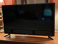 Front view of Samsung 32-inch LED TV powered off on stand