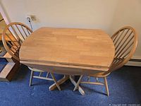 Top view of table with leaves down and two chairs