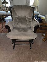 Front view of tan velour cushioned wood glider chair
