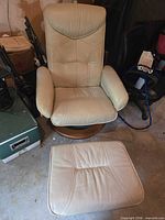 Front view of recliner and ottoman showing upholstery and base