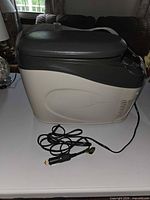 Right side view of Vector cooler showing strap, body shape, and 12-volt cord with plug