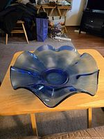 Angled view of entire blue glass bowl on table
