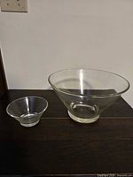 large and small clear glass bowls side by side on table